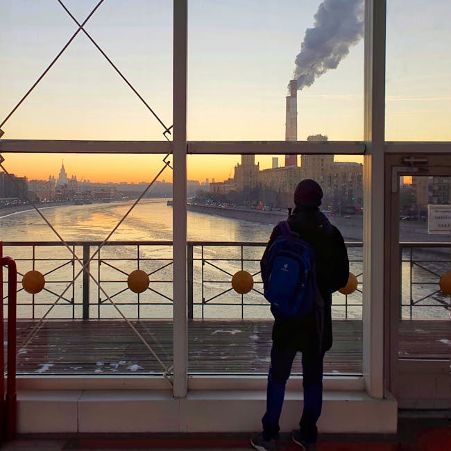 Person looking out a large loft window at the Chicago river - loft apartments magnificent mile chicago Person looking out a large loft window at the Chicago river - loft apartments magnificent mile chicago