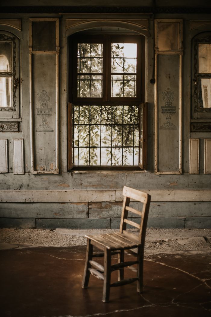 A single old wooden chair in a bare room — photo by Amine on Pexels