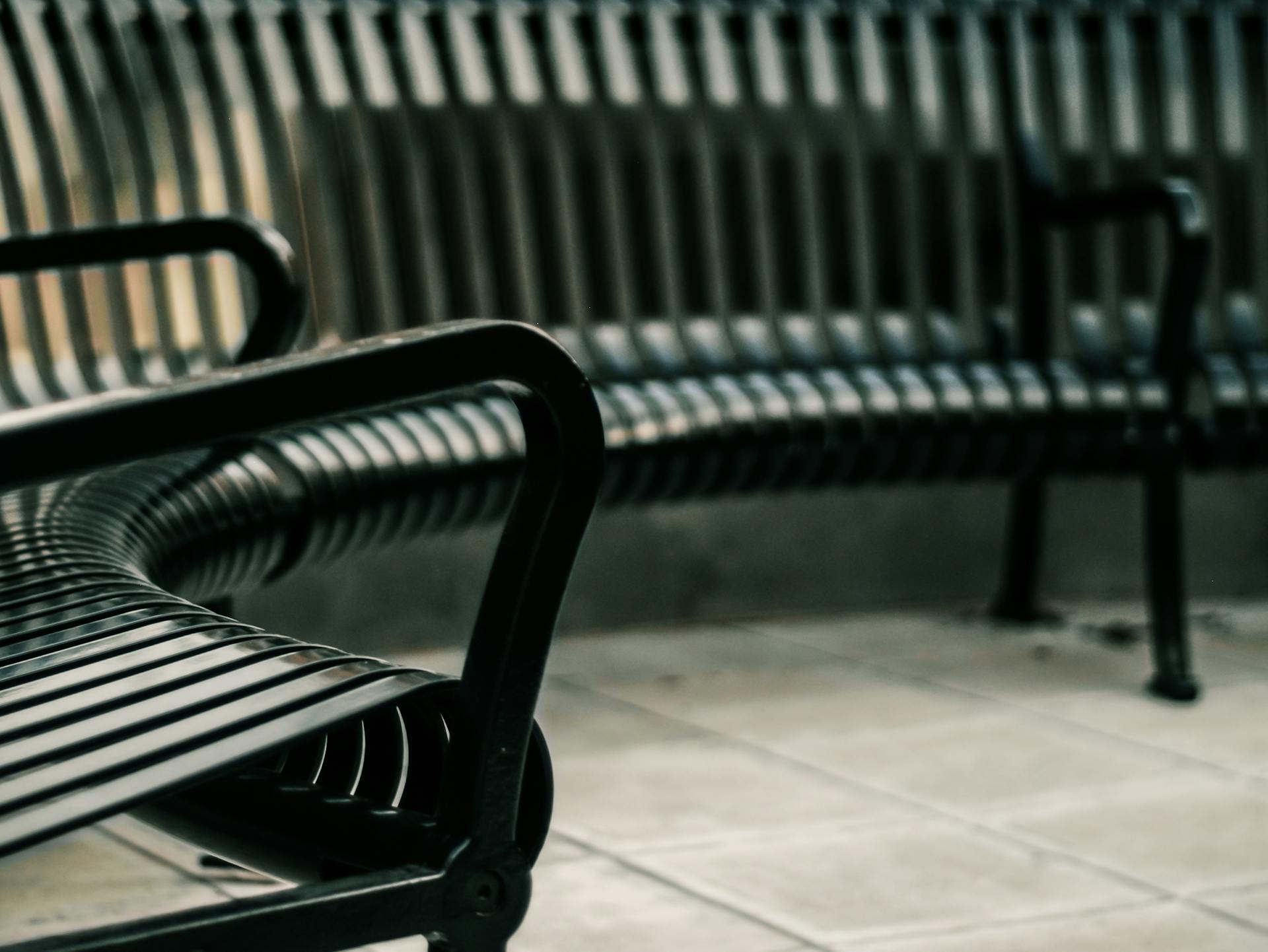 Curved metal benches in a contemporary outdoor space, perfect for seating.