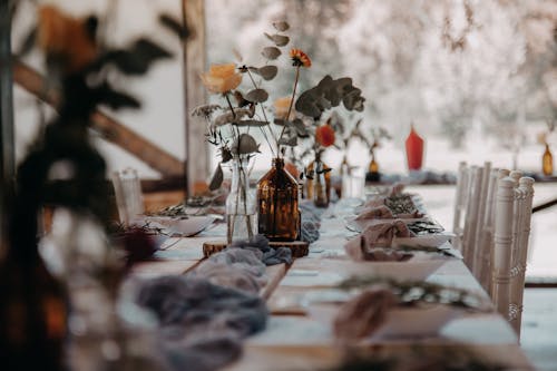 A Dining Table with Flowers in the Vase