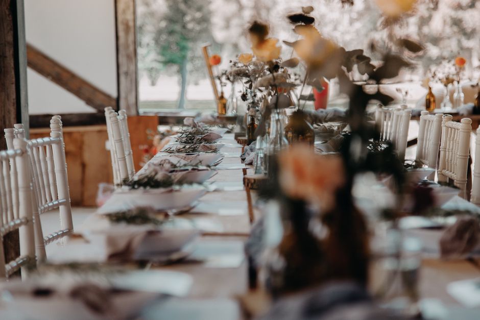 A beautifully set indoor table with floral decor, perfect for weddings or special events.