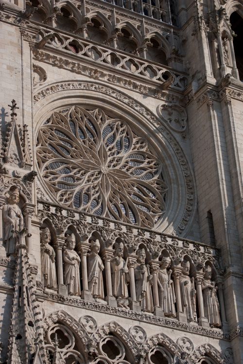 Free Close-up of Amiens Cathedral's gothic facade showcasing detailed sculptures and a stunning rose window. Stock Photo