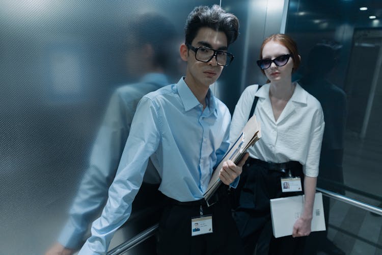 A Man And Woman Inside The Elevator