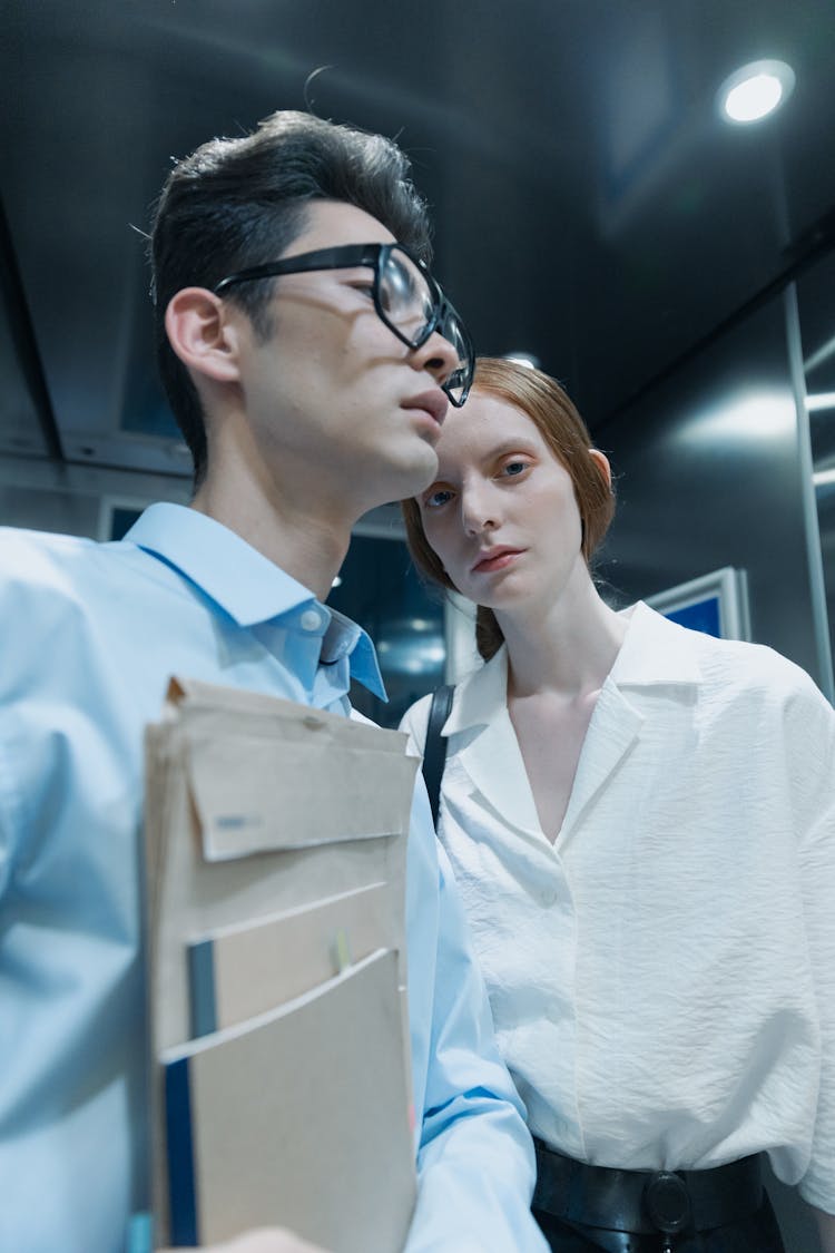 A Low Angle Shot Of A Man And Woman Inside The Elevator