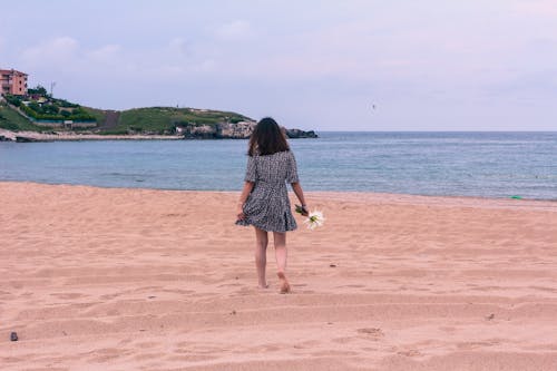 Woman in Short Dress Walking on the Beach