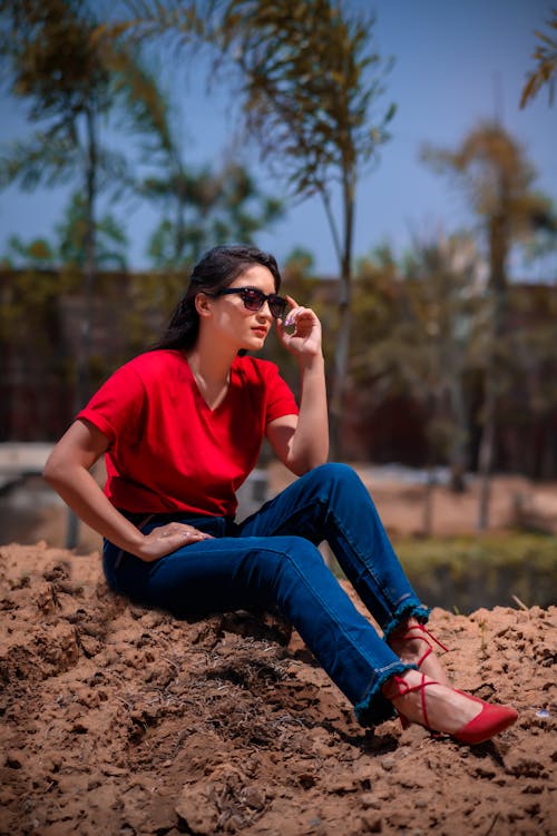 Woman in Red Shirt sitting on Mud