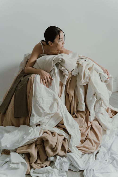 Woman in a Pile of Fabrics