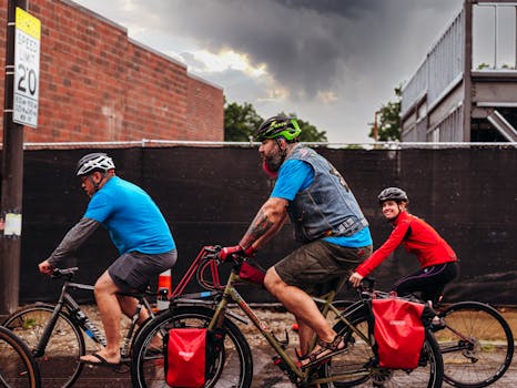 Three cyclists ride in the city during daytime, showcasing outdoor leisure and fitness.
