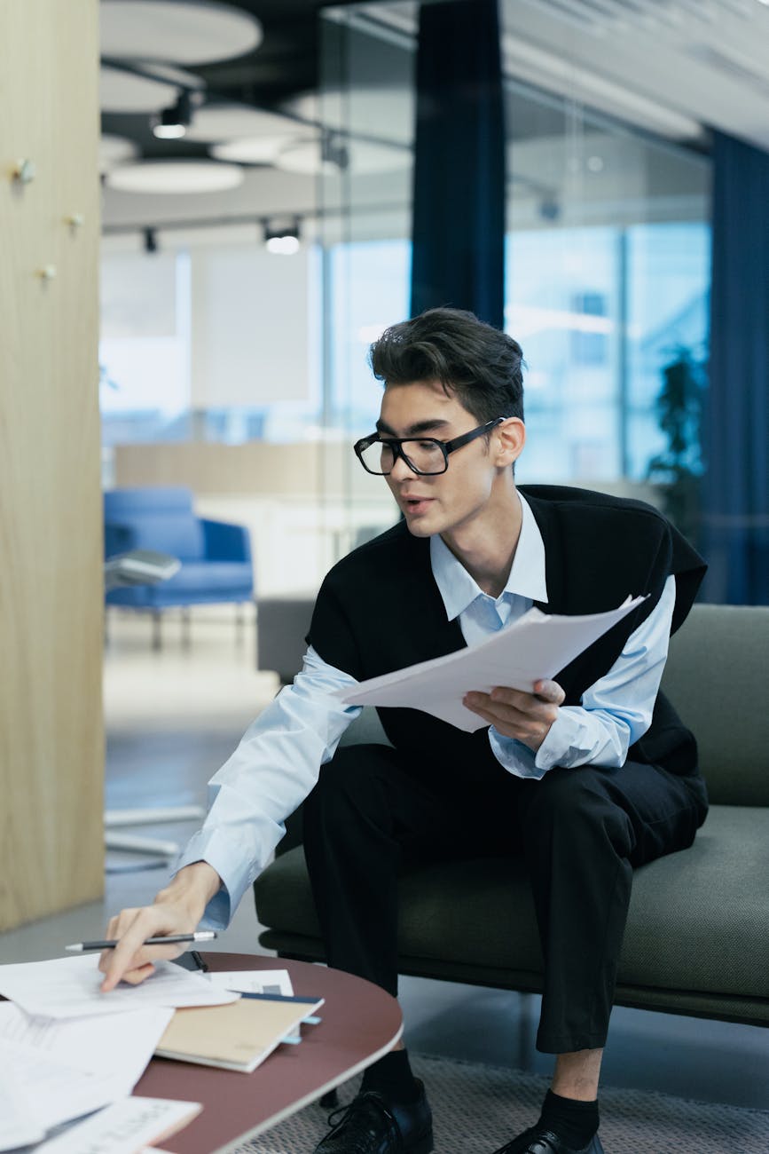 How to Reach the AI Consulate in Germany: A Comprehensive Guide Focused young professional organizing paperwork in a modern office setting.