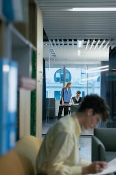 Contemporary office setting with professionals focused on work, highlighting collaboration and productivity.