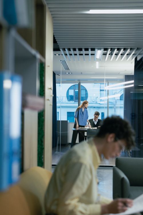 Free Contemporary office setting with professionals focused on work, highlighting collaboration and productivity. Stock Photo