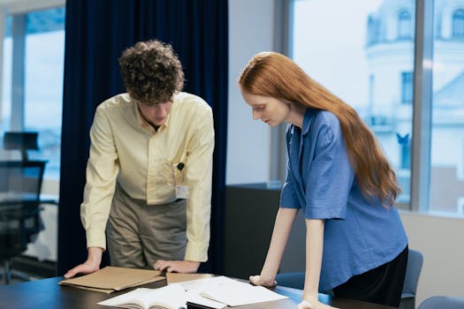 Business professionals collaborating on a project in a modern office space.