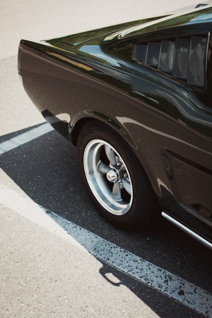 Close-up of a polished vintage car's rear, showcasing its glossy finish and retro design.