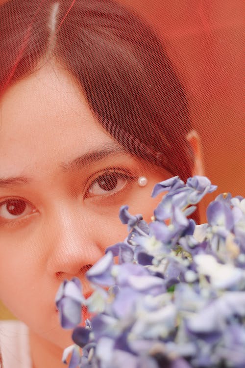 Free Blue Flowers Near A Woman's Face Stock Photo