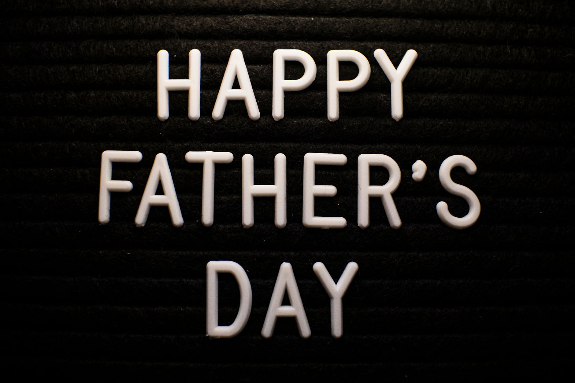 White letters on a black board spelling out Happy Father's Day, perfect for celebrations.