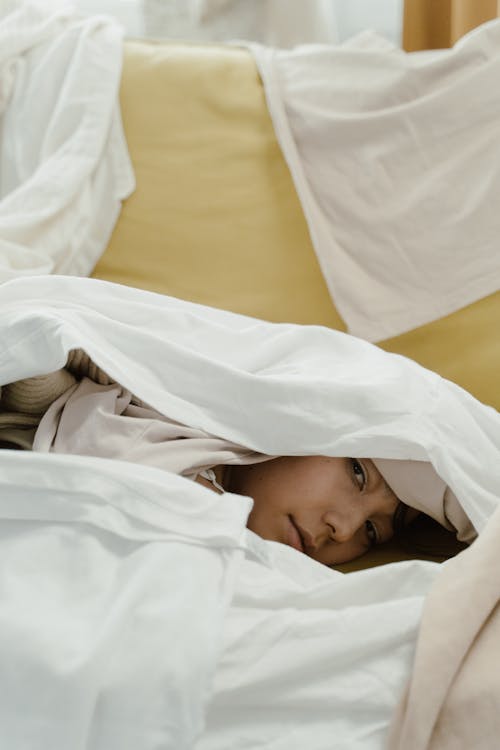 Free Woman Lying Covered With White Blanket Stock Photo