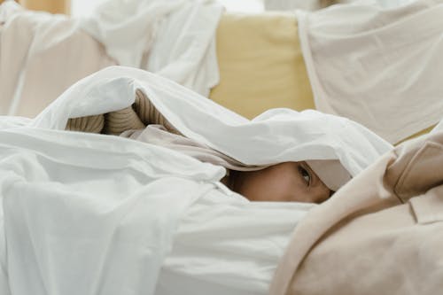 Free Person Lying Covered With White Blanket Stock Photo