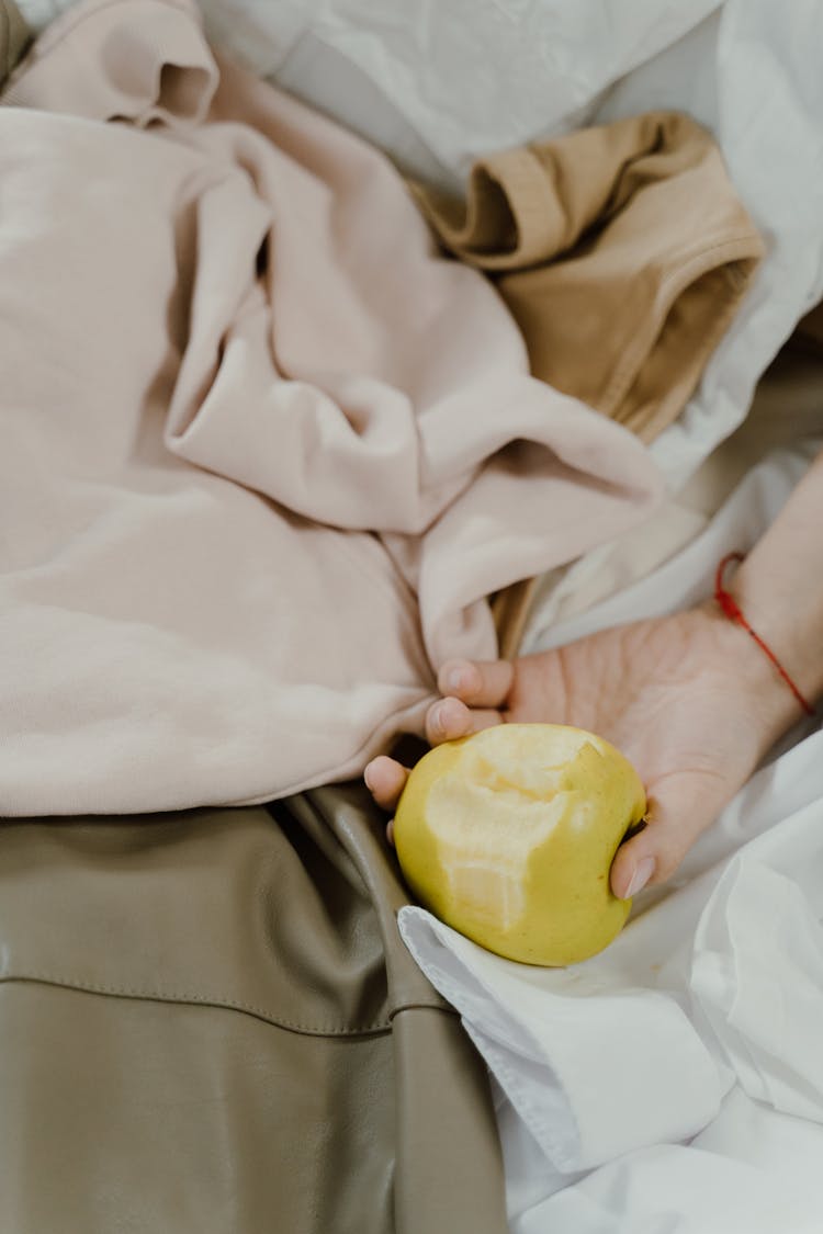 Hand Holding A Bitten Apple 