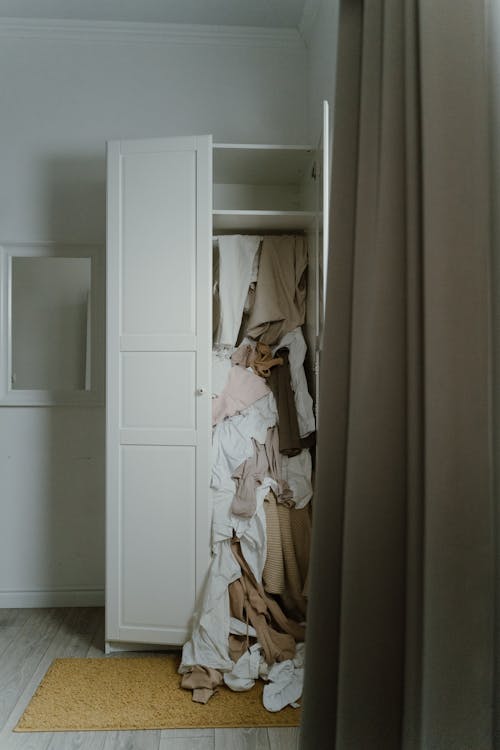 Free Photo of an Untidy and Messy White Wooden Closet Stock Photo