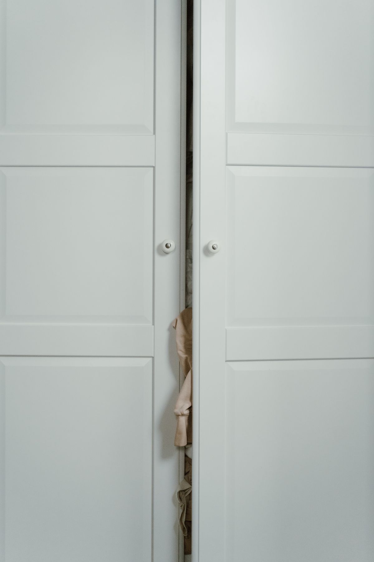 White hinged door wardrobe with clothes storage