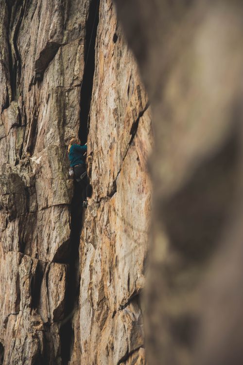 Free A daring rock climber scales a challenging cliff in Gastonia, North Carolina. Stock Photo