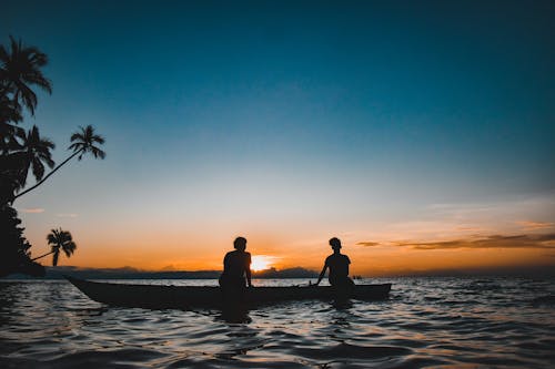 Silhouette of People on a Boat during Sunset