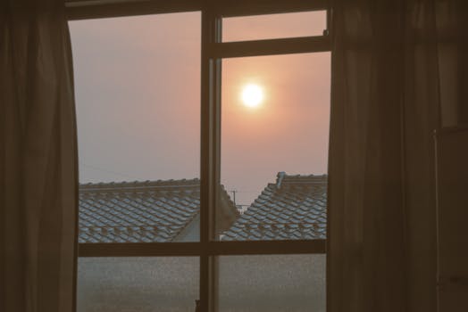 Tranquil sunrise seen through a window in Izumo, Japan, capturing the peaceful morning light.