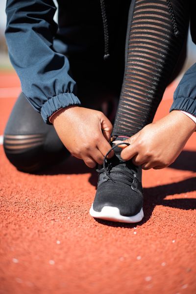 Runner tying shoelaces before a workout