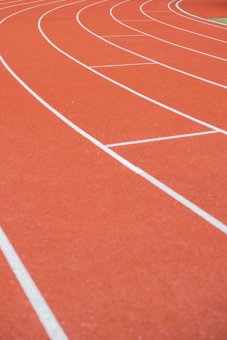 Curved lane lines on an outdoor running track — Mikhail Nilov on Pexels