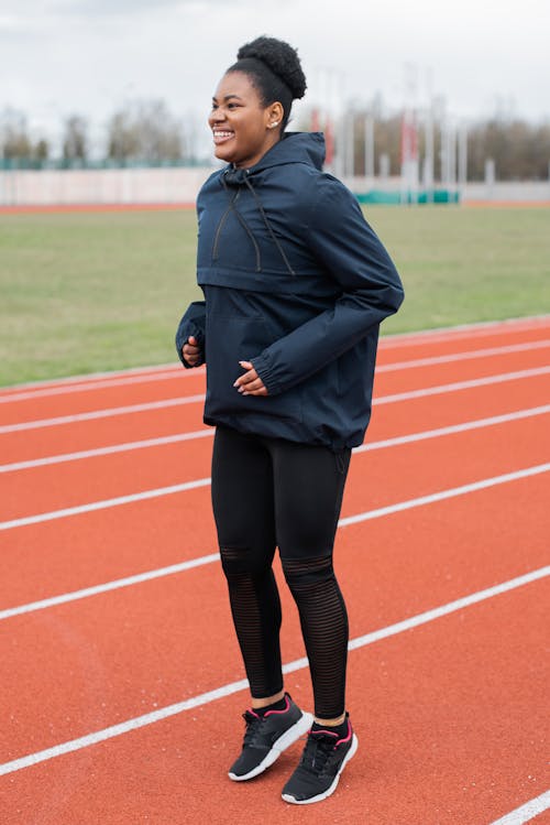 A Woman Standing on Running Track