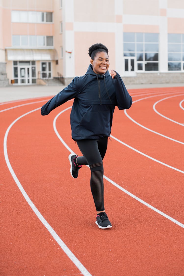 Woman Running On Running Track