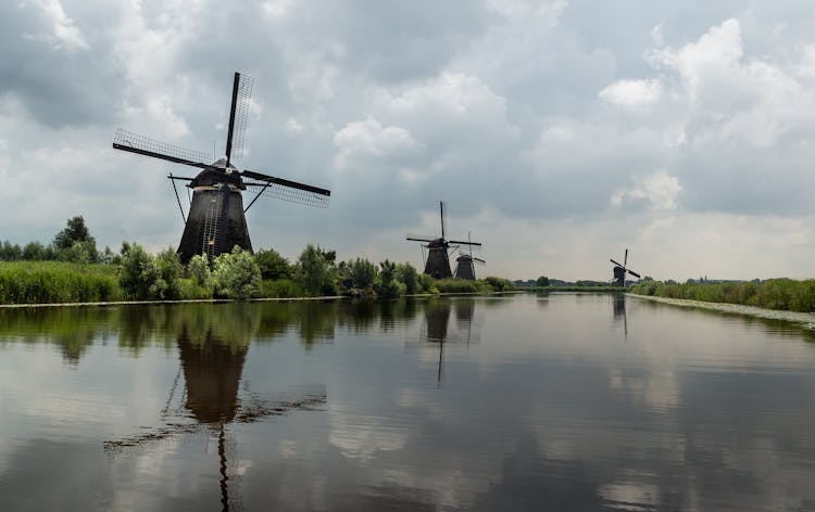 Old Windmills Along A Canal 