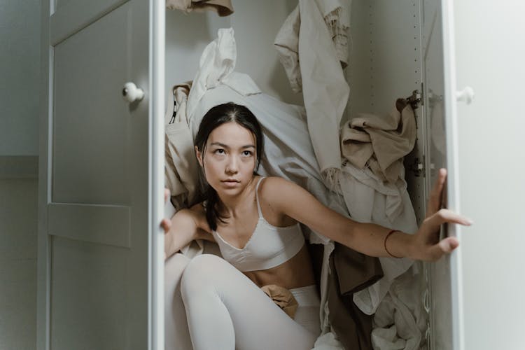 A Woman Sitting In The Wardrobe