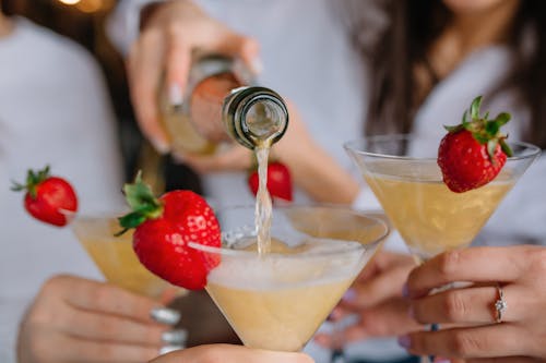 Free A Person Pouring Cocktail Drink in a Glass Stock Photo