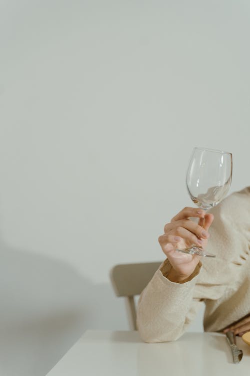 A Person Holding a Crystal Goblet Glass