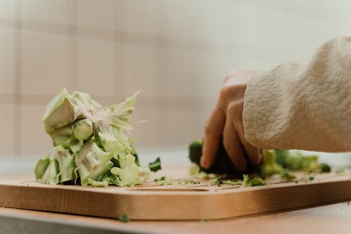 Close-Up Shot of Person Cutting a Broccoli