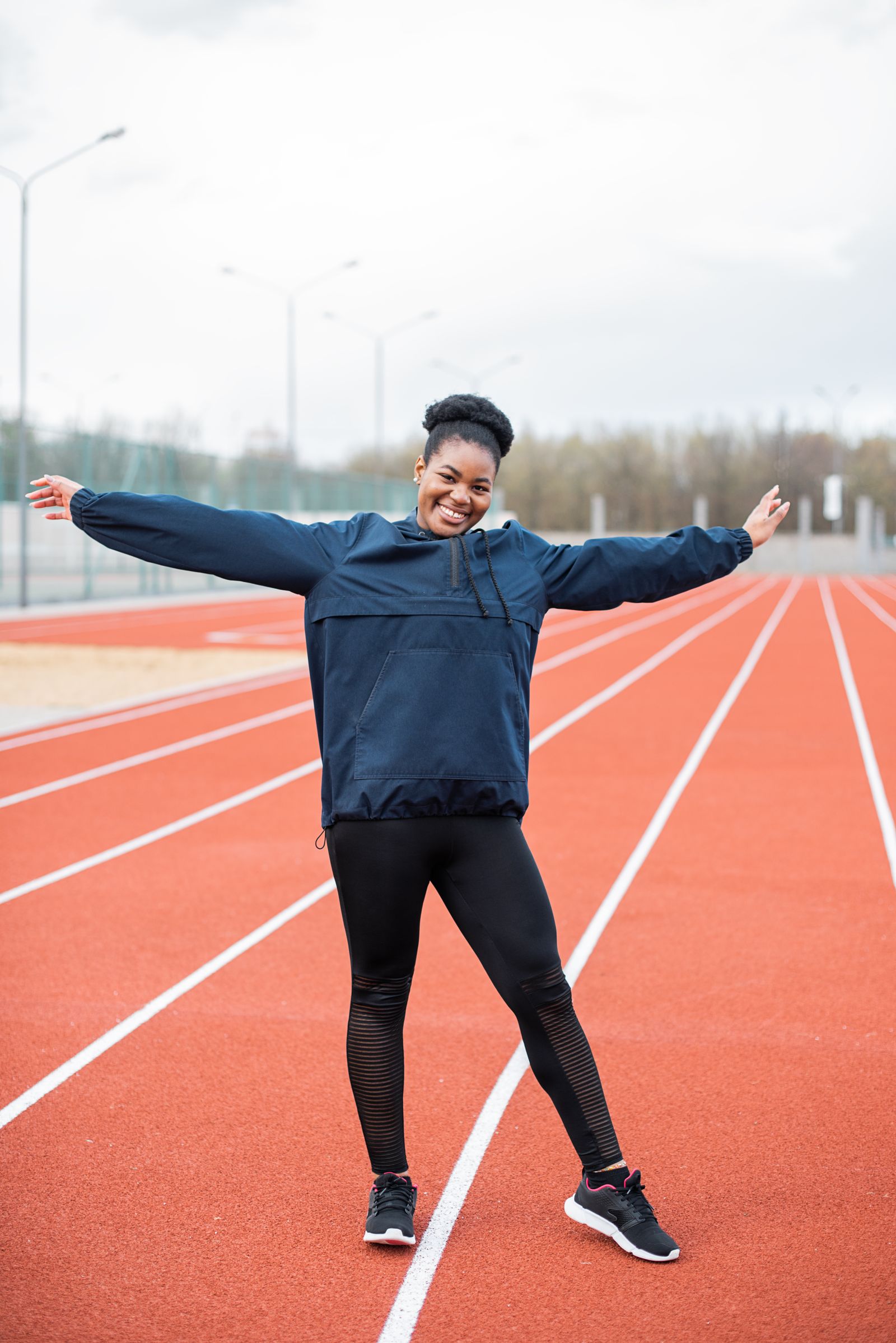 Woman in neon windbreaker and sneakers