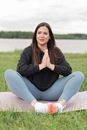 Woman in Black Long Sleeve Shirt and Blue Denim Jeans Sitting on White Textile