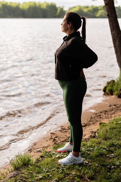 Woman with Her Eyes Closed Standing Near the Lake · Free Stock Photo