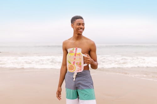 Smiling Man Holding a Summer Signage