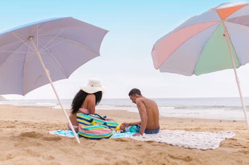 People Sitting on Shore at the Beach