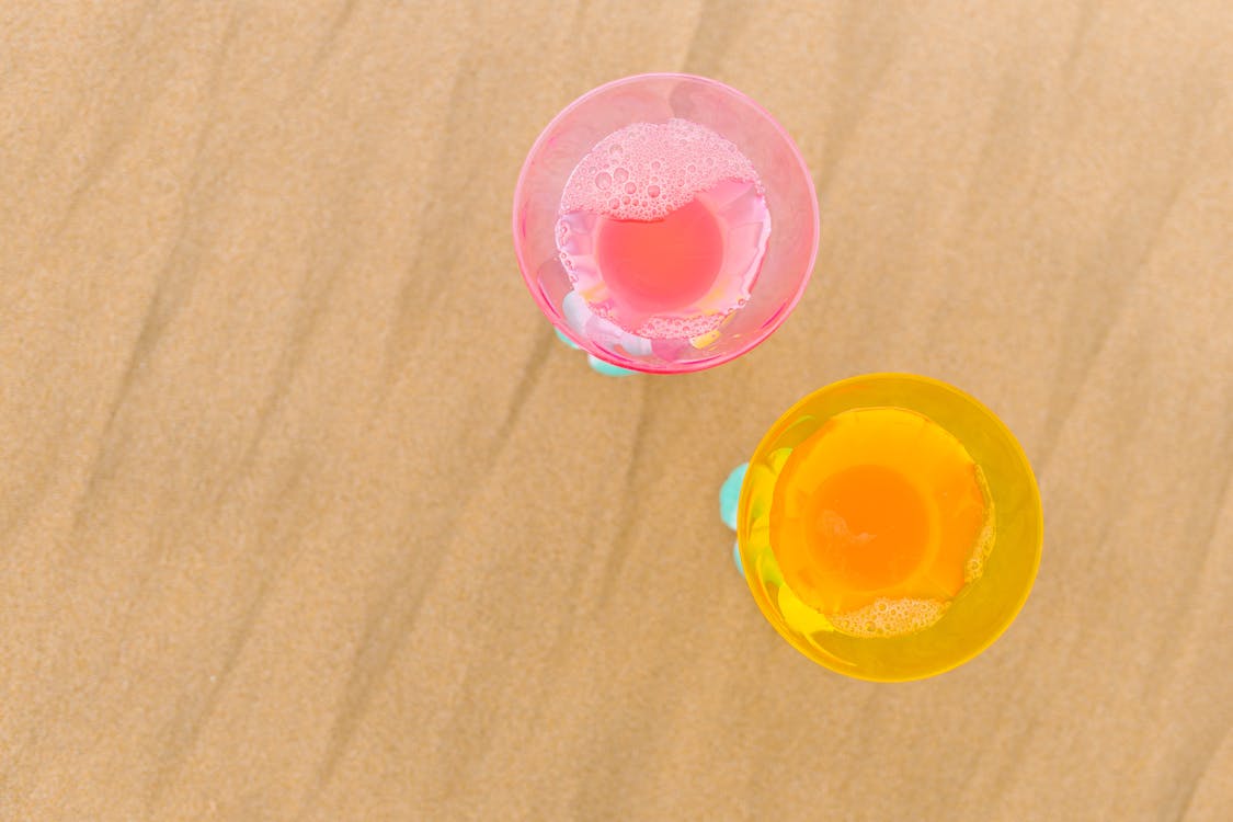 Free Cocktail Glasses on the Sand Stock Photo