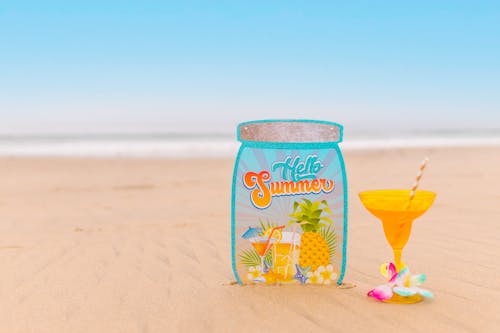 Free Yellow Cocktail Glass on the Sand Stock Photo