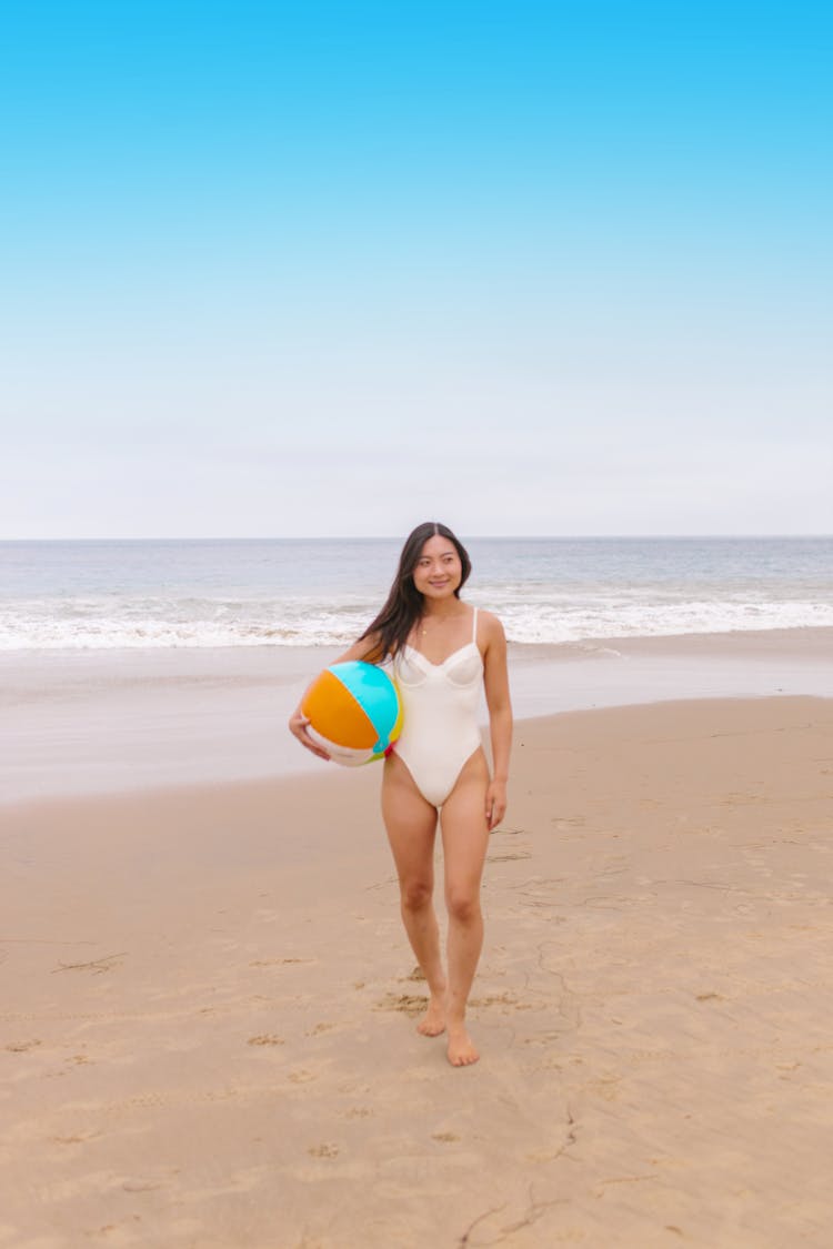 A Woman Holding A Beach Ball 