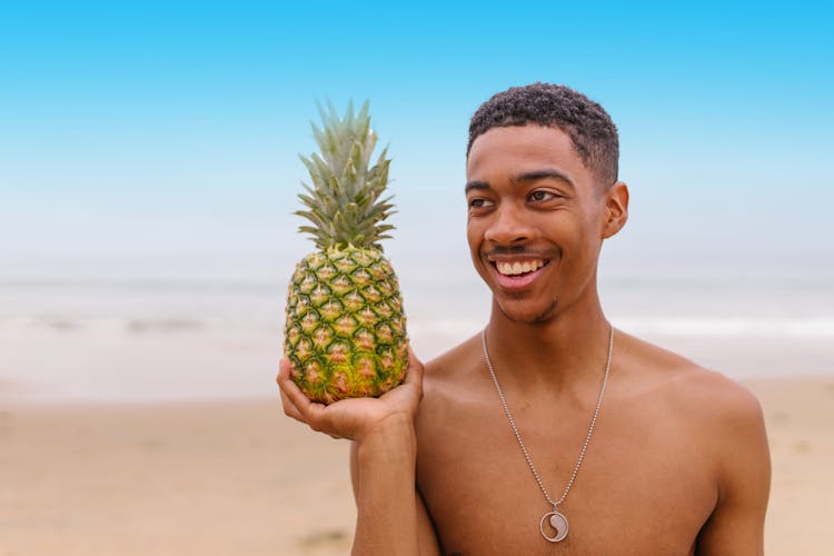 A Man Holding Pineapple