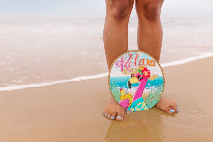 A Flamingo Wall Decor On A Person's Feet