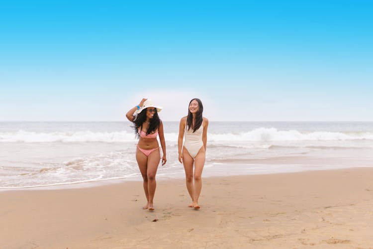 Two Women Walking On The Beach