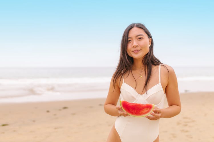 A Woman Holding A Sliced Watermelon