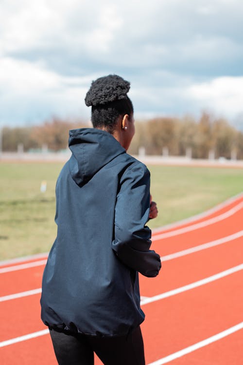 Free A Person in Black Jacket Jogging Stock Photo