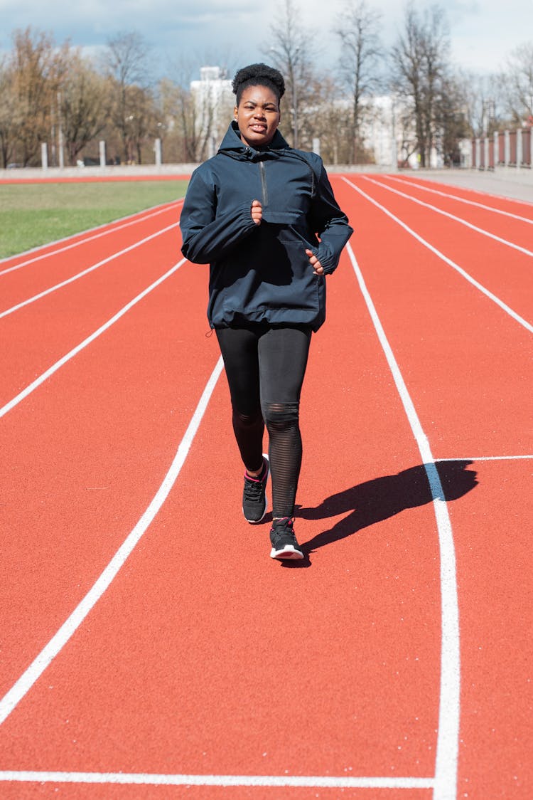 A Woman Jogging At A Running Track